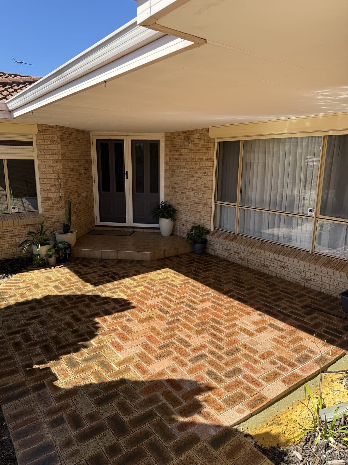 Red clay brick pavers laid in a herringbone pattern, Perth courtyard