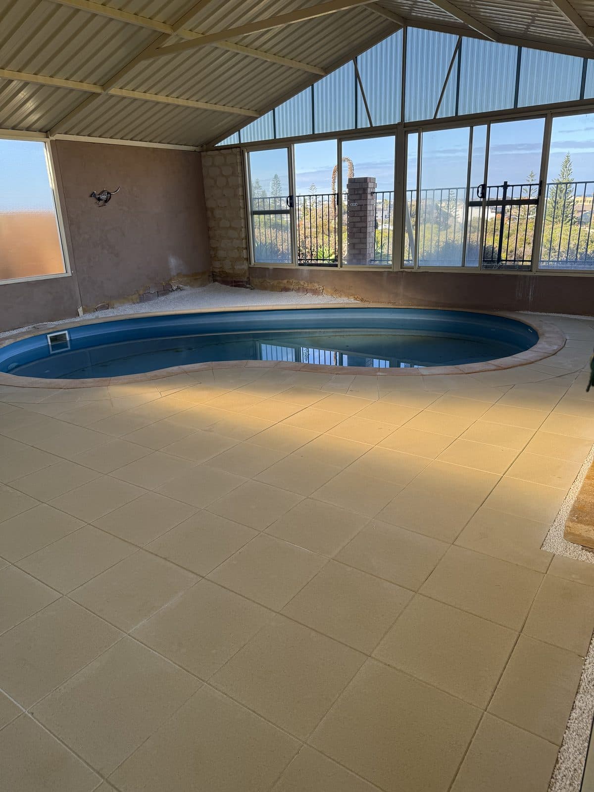 Cream pavers laid around an indoor pool